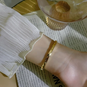 Polished 18k gold plated stainless steel cuff bracelet with elegant rhombus texture design