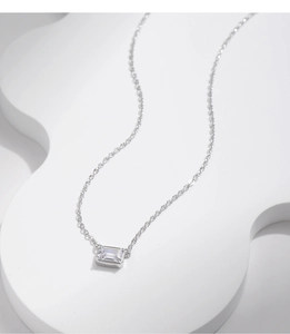 Detailed view of rectangle cut clear zircon pendant on fine silver necklace chain
