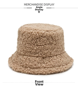 Detailed texture of soft beige sherpa fleece fabric on a round bucket hat for winter
