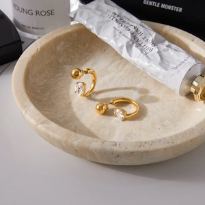 Detail of 18K gold-plated stainless steel C-hoop earrings with oval cubic zirconia inlay