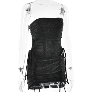 Detailed view of black glitter bodycon dress featuring side drawstrings and ties