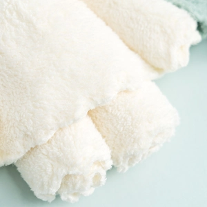 Macro shot of soft cream coral fleece towels with high-density plush microfibre texture