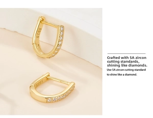 Macro shot of gold plated S925 silver U-shaped earrings with 5A cubic zirconia stones