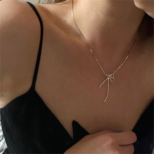 Minimalist 925 sterling silver bow knot pendant necklace on elegant woman neck