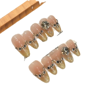 Sparkly champagne rose press-on nails with 3D rhinestones and cat-eye glitter design