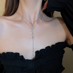 Detail of silver double-layered star tassel necklace with sparkling rhinestone accents