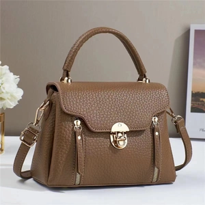 Brown litchi texture handbag with gold twist lock and adjustable shoulder strap