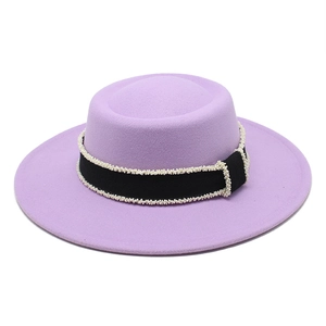 Detail of purple wool felt boater hat with black ribbon and white woven lace trim