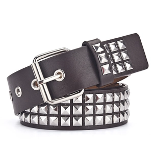 Close-up of Y2K punk rock leather belt with three rows of silver metal square studs