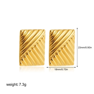 Close-up of 18K gold textured rectangular studs with dimensions 23mm by 18mm and 7.3g weight