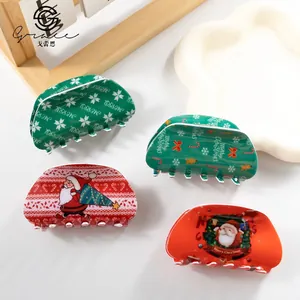 Set of four Christmas hair claws with Santa and snowflake motifs on red and green acrylic