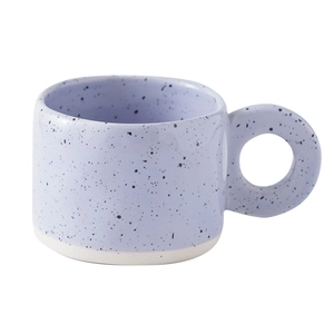 Minimalist lavender ink splash ceramic coffee mug with rounded handle on white background