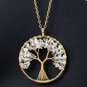 Detail of handmade gold wire-wrapped tree of life pendant with clear crystal stones