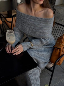 Detail of grey ribbed knit off-the-shoulder dress fabric and elegant neckline texture