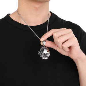 Detail of a punk mechanical skull pendant made of polished silver titanium steel