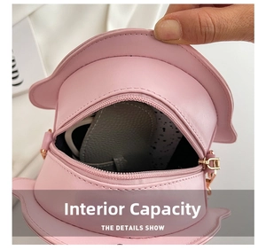 Detail showing the internal capacity of the pink animal-shaped chain crossbody bag