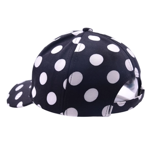 Detailed view of polka dot baseball cap with adjustable back strap on white background