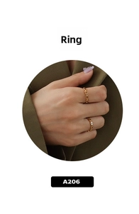 Detailed view of stackable gold-plated geometric link chain rings on a model hand