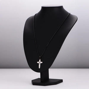 Three-layer stainless steel cross pendant necklace displayed on a black bust mannequin