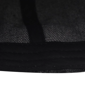 Detailed close-up of washed grey denim fabric showing twill texture and black binding seam