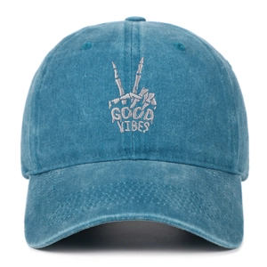 Detailed embroidery of a skull hand with GOOD VIBES text on a washed cotton baseball cap