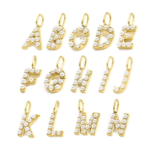 Detail view of 14 gold letter charms A to N with embedded pearls for DIY jewelry