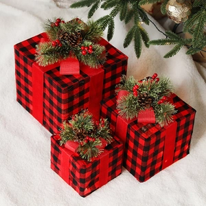 Three-piece red and black plaid Christmas gift boxes with pine cones and ribbons