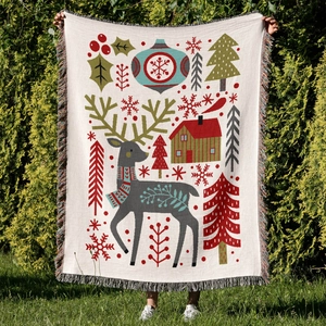 Detail of Christmas tree woven throw blanket with colorful tassels on outdoor grass