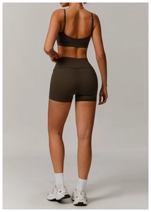 Rear view of women's racerback sports bra and high-waist shorts set in dark charcoal brown