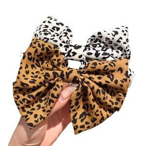 Set of two leopard print fabric bow hair clips in white and brown animal patterns