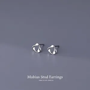 Minimalist S999 sterling silver Mobius stud earrings with polished twisted design