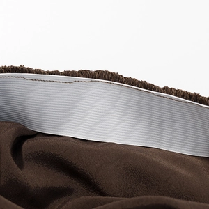 Detail shot of the elastic waistband with plush brown fabric and fine stitching