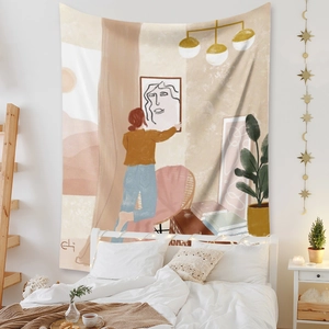 Detail of a Boho wall tapestry featuring abstract woman and plants in a cozy bedroom decor