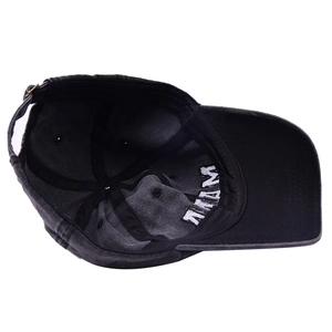Detail view of washed cotton baseball cap interior with smooth seams and metal buckle