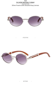 Detail view of retro oval sunglasses with silver metal frame and wood grain texture temples