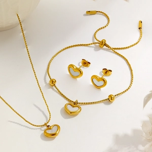 Elegant gold heart jewelry set including necklace bracelet and earrings with shell inlay