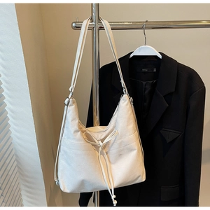 Minimalist off-white convertible canvas tote bag with drawstring and adjustable straps