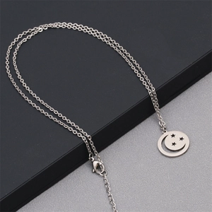 Polished silver stainless steel necklace featuring a hollow crescent moon and stars pendant