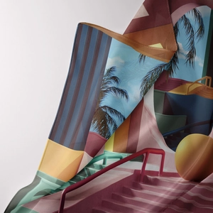 Detailed view of the soft silk-like fabric showing artistic palm trees and geometric patterns