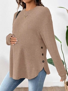 Detail of brown maternity knit top showing vertical ribbed texture and side buttons