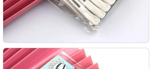 Detail of professional hair sectioning clips in packaging with non-slip silicone rubber band