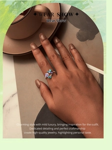 Detailed view of s925 silver ring featuring blue enamel bird and purple flower design