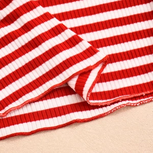Close-up of red and white striped ribbed knit fabric showing detailed sewing and texture