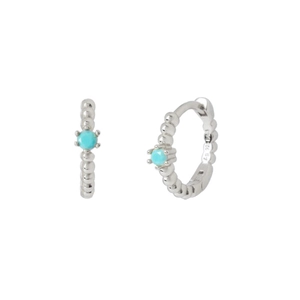 Macro detail of silver sterling hoop earrings featuring inlaid round turquoise stones