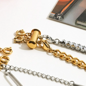 Detailed close-up of 18k gold and silver stainless steel layered necklace clasp connectors