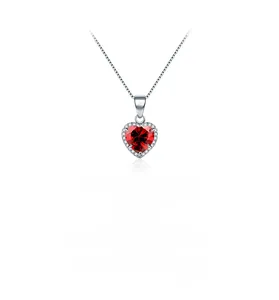 Macro detail of a S925 silver heart necklace with red zircon and crystal halo
