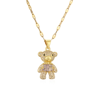 Gold plated bear pendant necklace with purple and white cubic zirconia on white background