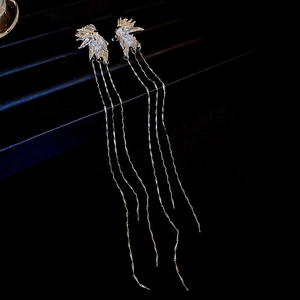 Detail of silver long tassel earrings with leaf design and sparkling zircon stones