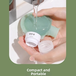 Close-up of filling a mint green silicone travel bottle with liquid soap under a faucet
