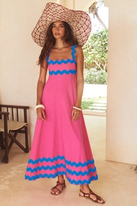 Detailed view of the pink maxi dress with blue scalloped edges and floral print